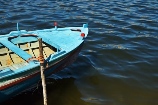 Old blue boat on water