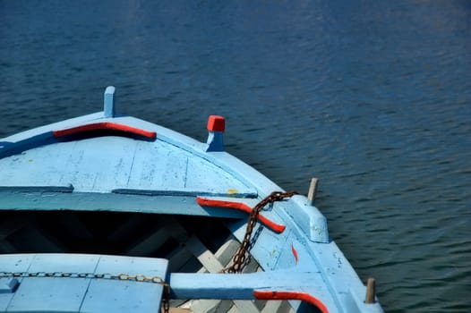 Blue boat detail with sea in the background