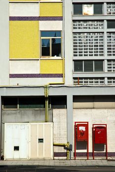 Two red mailboxes in Italian street