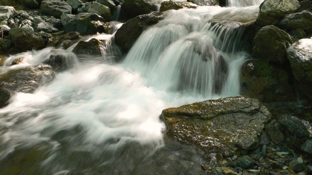 crystal clear water cascade on the japanese mountain river