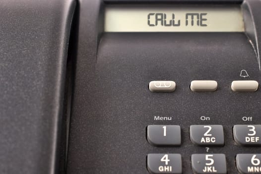 Black telephone detail with numbers and display with message