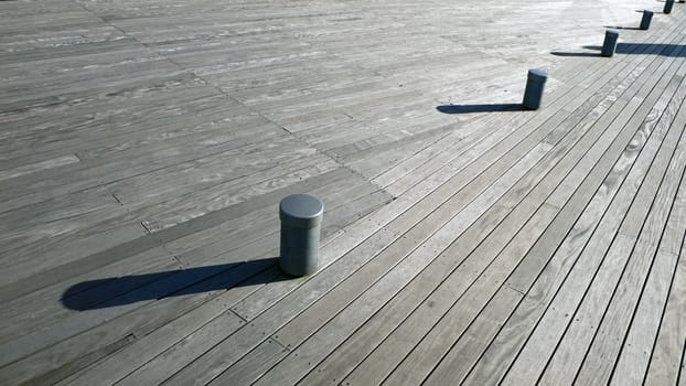 wooden deck background with small posts and long shadows
