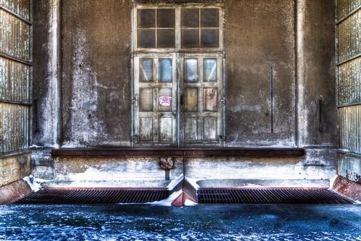 Entrance to old sinister building with snow