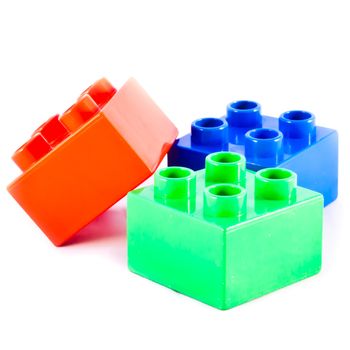 Plastic building blocks on white background. Bright colors.