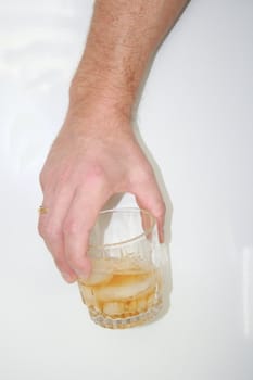 man holding alcoholic drink in a glass