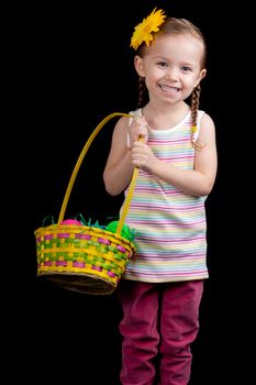 A happy young girl holding her easter basket.  She is on the hunt for more eggs.