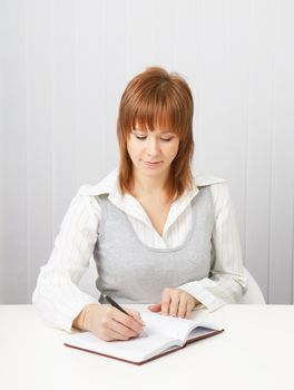 business attractive girl with a notebook and pen in the office.
