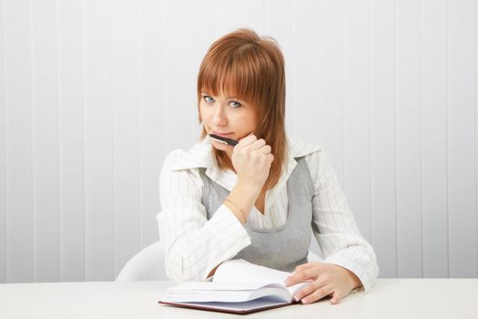 business attractive blue-eyed girl with a notebook and pen.
