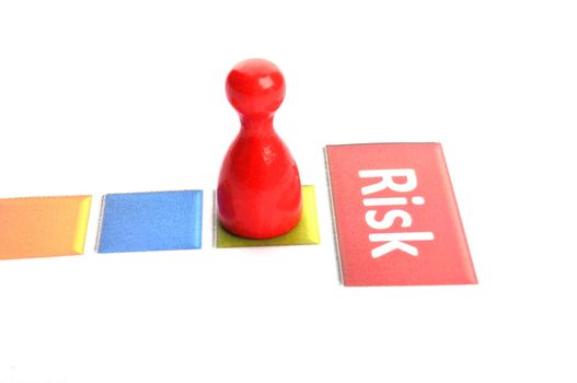 risk business concept with red pawn on white