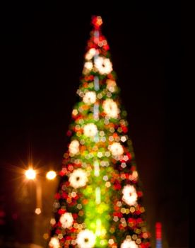 Christmas tree with blurred lights on black background