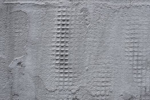 Detail of a wall covered with plastic mesh and construction glue