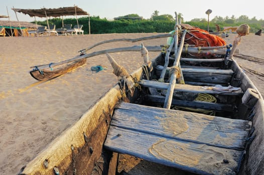Old wooden fishing boat on the sandy beach