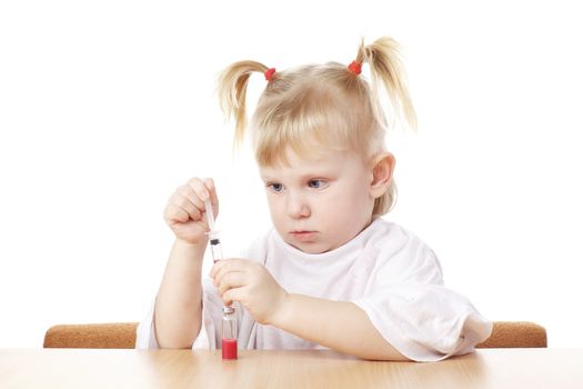 child playing as a scientist with syringe