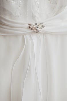 part of a wedding dress with brooch