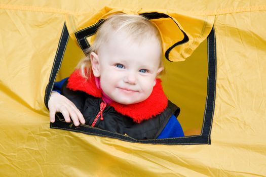 small girl looks out of the window tent