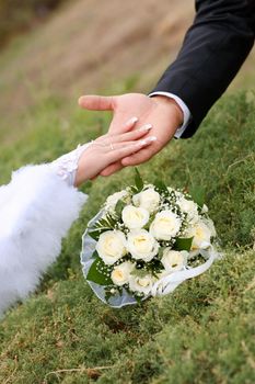 two hands over flower bouquet
