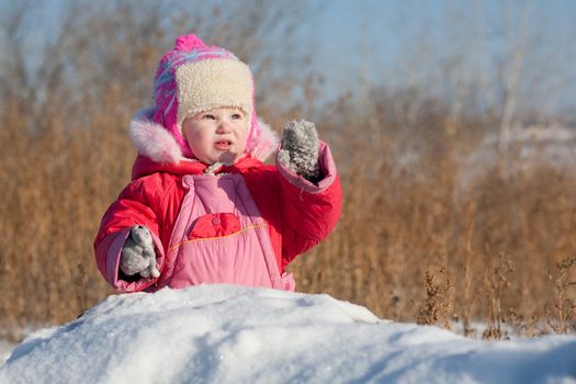 small child playing in winter