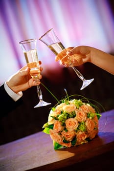 champagne in hands of bride and groom