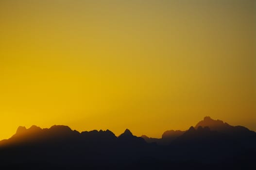 sunset in the desert mountain silhouettes in background.....