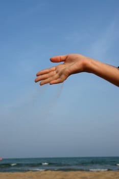 sand running through hands as a symbol for time running, lost etc.............