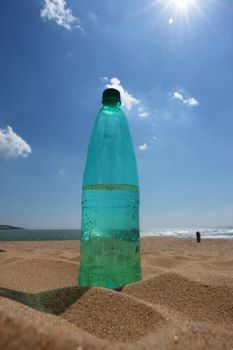 water bottle at the beach on a hot day