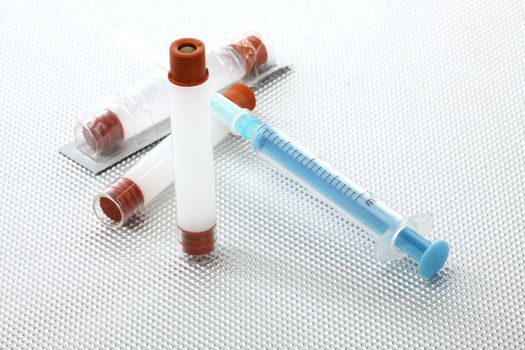 insulin vials and syringe close up, shallow dof