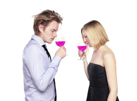 Young couple toasting with pink drink. Two people drinking. Studio photo., isolated.