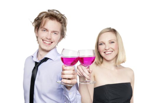 Young couple toasting with pink drink. Selective Focus. Studio photo, isolated.