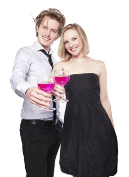 Young couple toasting with pink drink. Two people drinking. Studio photo, isolated.