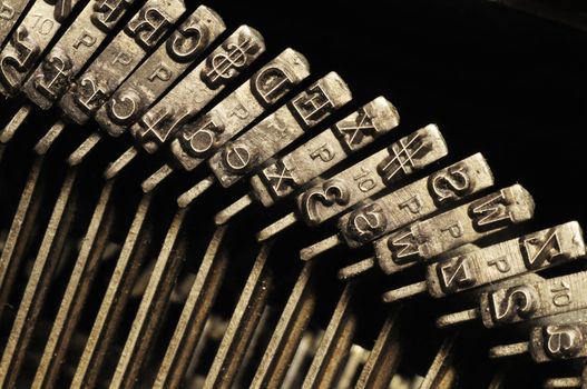 Close-up of the striking surface of old typewriter letter and symbol keys