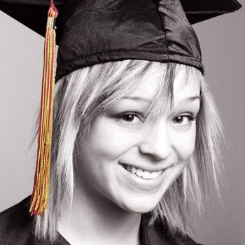 A beautiful young woman is happy to be graduating her school with a sense of an accomplishment.