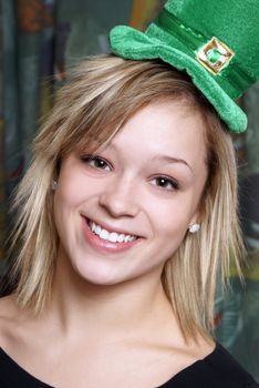 An attractive young girl is happily celebrating St Patricks Day.