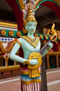 Crying fairy string player stucco in Thai traditional art and craftsmanship at a rural Thai temple.