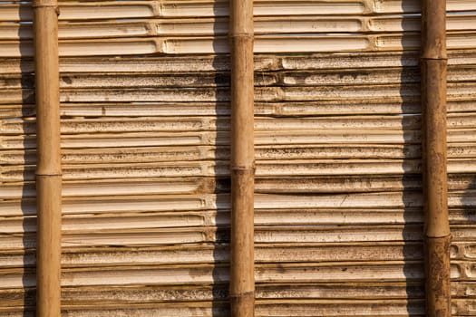 The bamboo panel made from pieces of bamboo wood and arranged in asian traditional pattern.