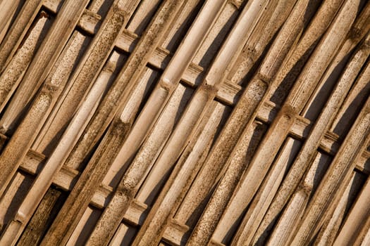 The bamboo panel made from pieces of bamboo wood and arranged in asian traditional pattern.