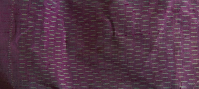 Thai silk made from pure natural silk thread and dye by chemical dark purple colour with old style traditional knowledge  original gray pattern.