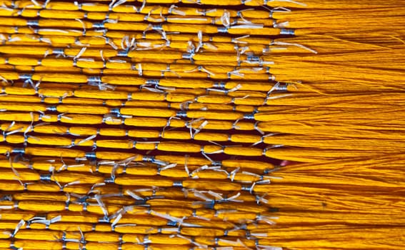 Yellow natural Thai silk thread  is preparing to dye by chemical colour in origin traditional knowledge.