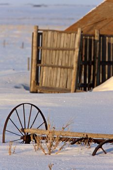 Old Barn and Wagon Wheel in Winter Saskatchewan