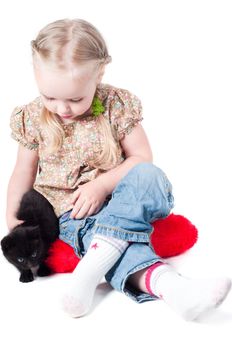 Shot of little girl playing with kitten