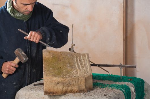 Sculptor just starting to carve art out of stone