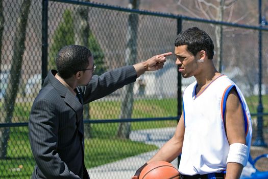 A young basketball player gets yelled at by his coach.