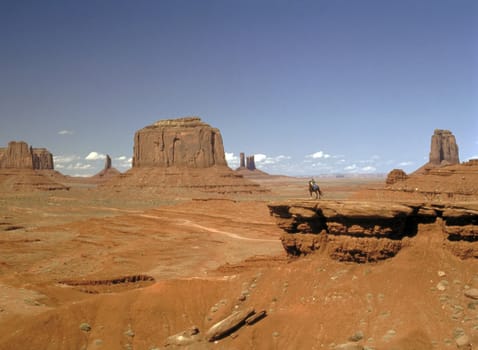 Navajo girl on horseback in Monument Valley