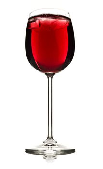 Wine glass with red fruit juice and ice on a white background