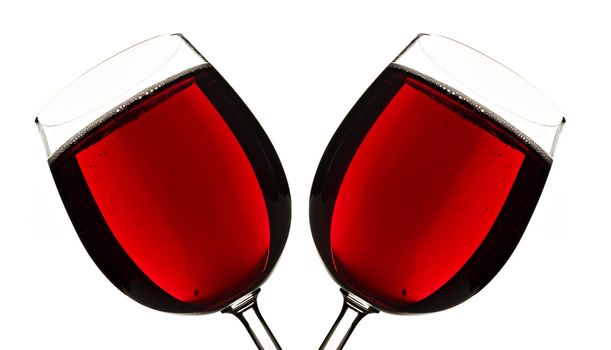 Close up of two glasses of red fruit juice on a white background