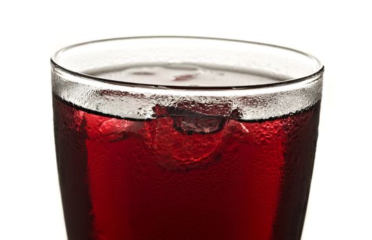 Close up of  a glass of red fruit juice on a white background