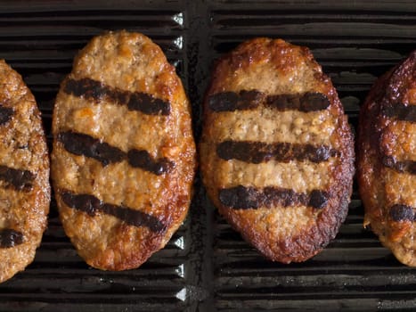 grilled beef patties on a grill