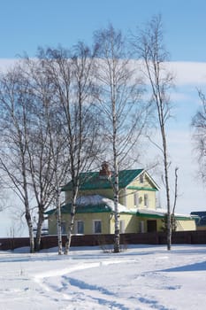 a small wooden house in a snowy forest 