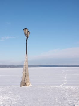 Lantern on the bank of lake in the winter 