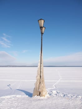 Lantern on the bank of lake in the winter 