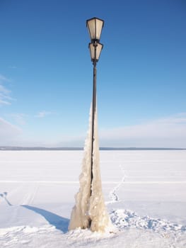 Lantern on the bank of lake in the winter 